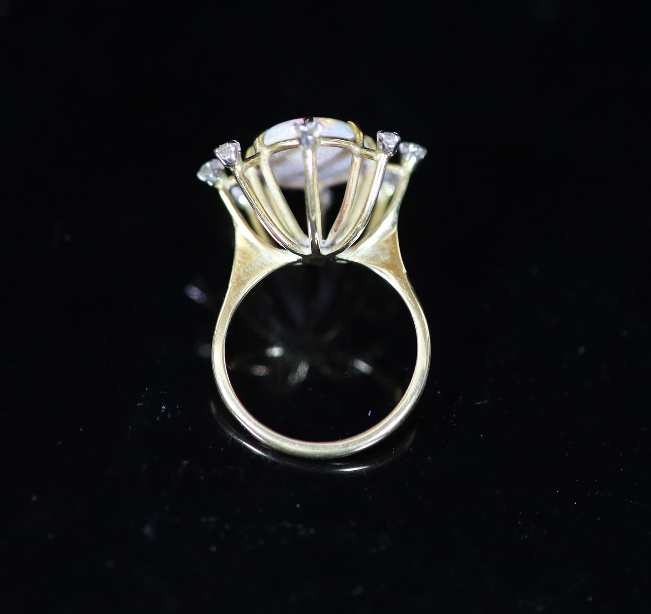 An 18ct gold, single stone oval white opal and eight stone diamond set modernist ring